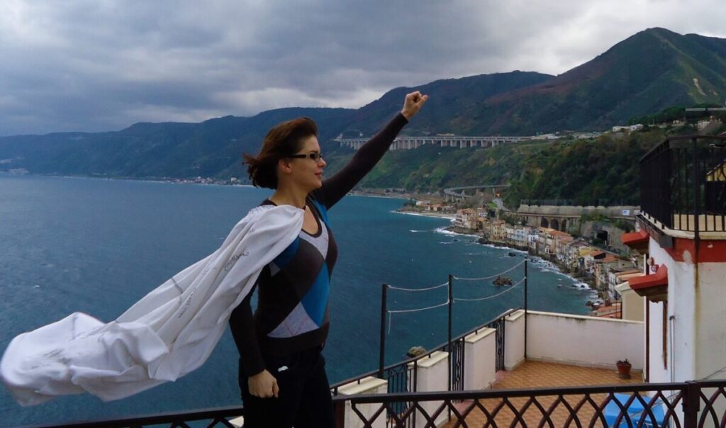 Superwoman standing at the rock of Scilla
